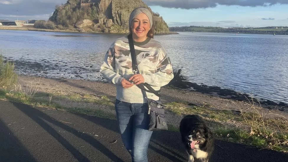 A Border Collie and her owner at the beach
